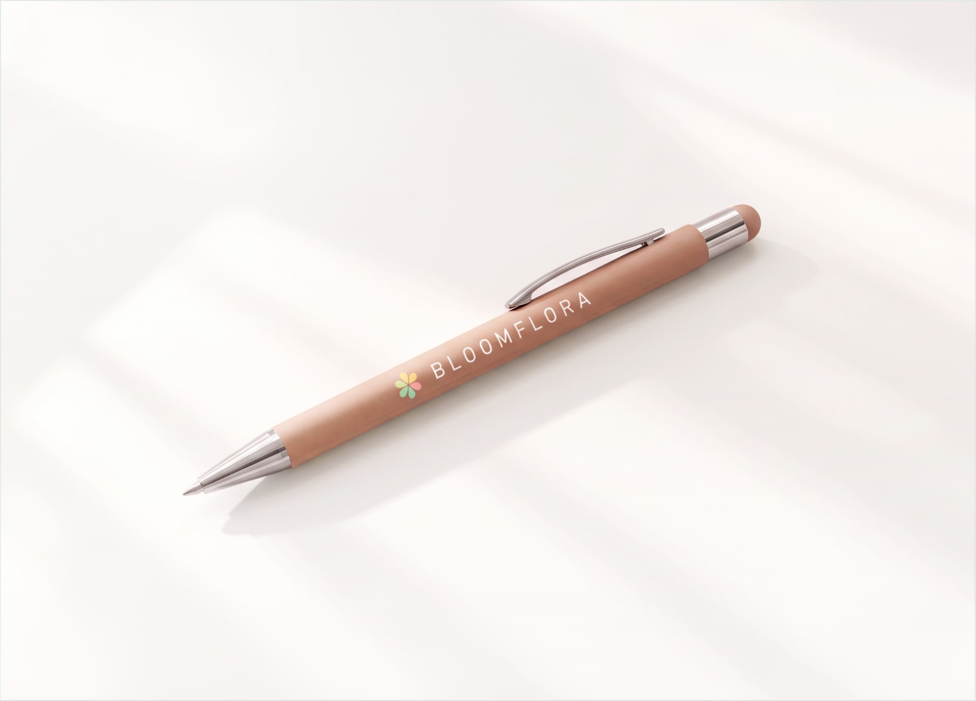 A custom Bowie pen in a painted rose finish with chrome trim and a full-color logo
